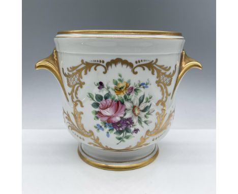 Elegant footed Limoges porcelain cachepot with an ornate gold pattern and handles. Features hand painted floral arrangements.