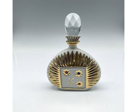 Lovely white porcelain bottle designed with gilt sunburst design surrounding flowers with Swarovski crystal centers. Stopper 