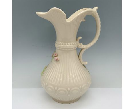 Gorgeous Irish ceramic vessel with raised floral decor and a scroll handle. Belleek backstamp. Issued: 20th centuryDimensions