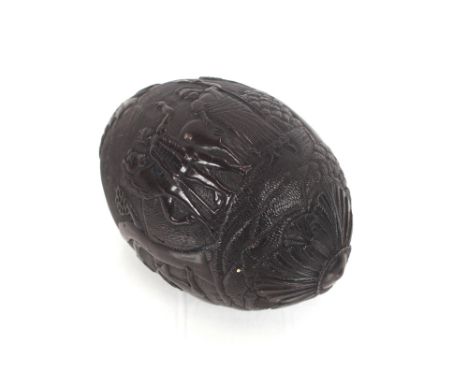 An 18th Century "Bugbear" carved coconut flask, decorated hunting scenes and foliage, 13cm long&nbsp;