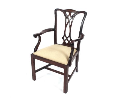 A set of eight reproduction mahogany Chippendale style dining chairs, with upholstered drop in seats raised on square section