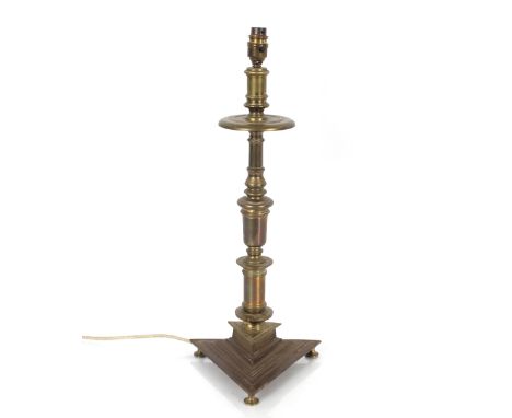 An antique brass table lamp, having baluster column and triform base, 57cm high overall