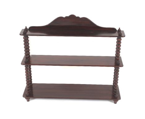 A near pair of 19th Century rosewood and simulated rosewood wall shelves, of graduating form supported on turned bobbin colum