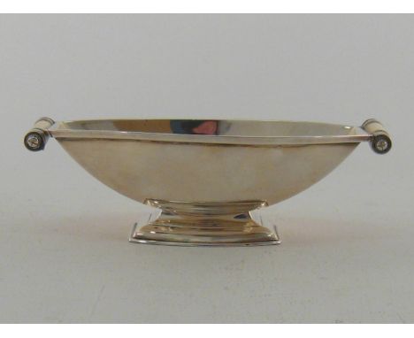 A silver Art Deco sweet dish by Adie Brothers, Birmingham, 1930, rectangular with curved sides and pedestal foot, cylindrical