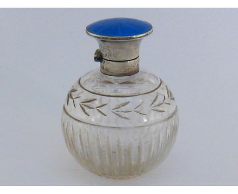 A silver and enamel capped cut-glass scent bottle by Albert Carter, Birmingham, 1925, spherical and cut with fluting below ba