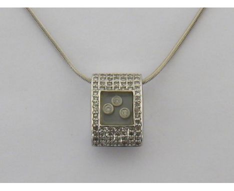A diamond pendant, in the style of Chopard, the box pendant of oval section pave set overall with a central glazed panel reve