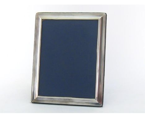 A modern silver-fronted photograph frame of plain oblong design, mark of RC, Sheffield, 2003, blue velvet easel back, 23.2 cm