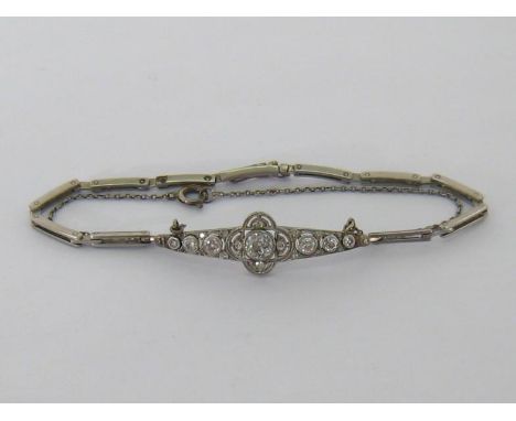 An Art Deco diamond bracelet, the central tapering plaque set with old cut brilliants, the principal stone approx. 0.52 carat