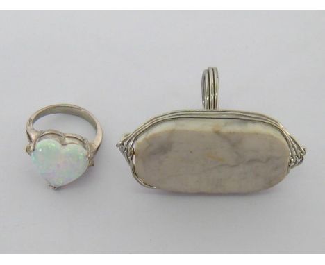 Two dress rings, including one set with a synthetic opal and the other with a large hardstone bezel, both mounted in white me