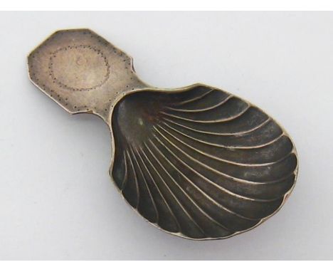 An Old Sheffield Plate caddy spoon, circa 1800, octagonal handle with vacant navette cartouche, scalloped bowl, 7.5 cm. long 