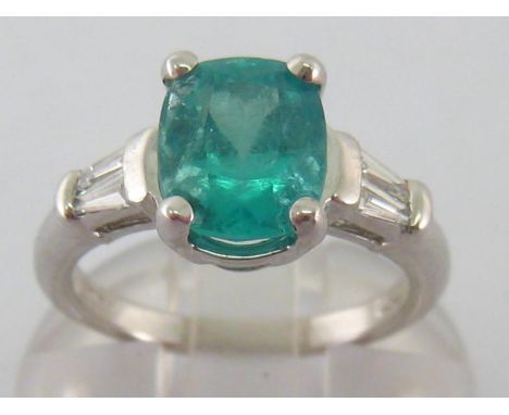 A Columbian emerald and diamond ring, the rectangular cushion cut stone 2.09 carats, claw set above tapered baguette cut diam