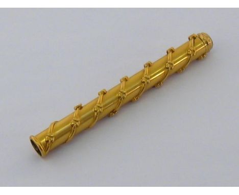An early 20th century 18 carat gold retractable dip pen and pencil, the cylindrical case with spiral and clover design in rel