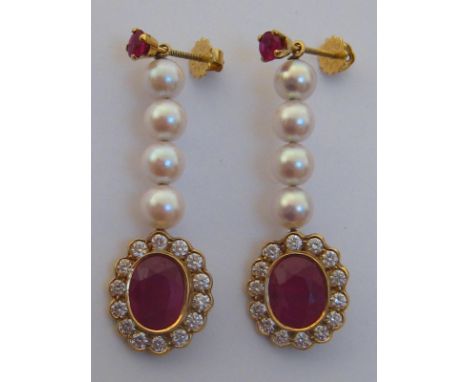 A pair of ruby, diamond and cultured pearl drop earrings, each principal drop with a collet set oval cut 9.1 x 7.2 x 3.9 (dee