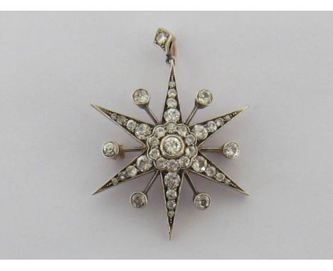 A late Victorian diamond starburst brooch/pendant, the central rub over set old cut brilliant in a surround of smaller old cu