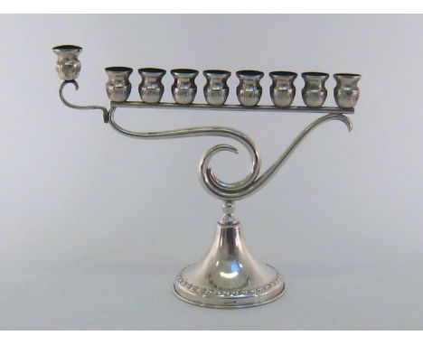 Judaica:- An Israeli white metal menorah stamped "Hazorfim 925", the eight lights and detachable auxiliary light on openwork 