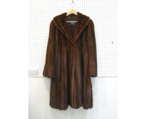 A medium three quarter length brown mink fur coat by Cleiren, with brown polyester satin lining, double hook fastening 