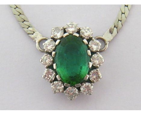 A green toumaline and diamond cluster pendant, the central oval cut stone 8.15 x 11.7mm in a surround of 12 brilliants totall