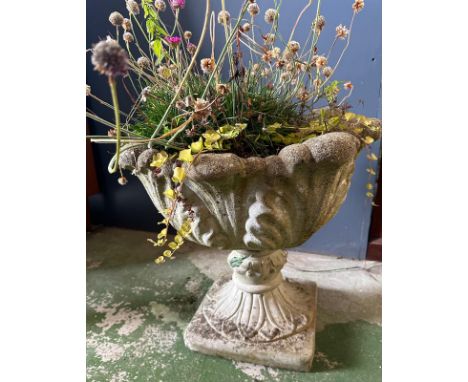 A concrete garden planter with leaf design 
