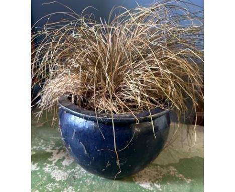 A cicrculr blue glazed garden planter 