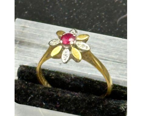 A ruby , diamond and 18ct gold daisy style ring, approximate weight 2.4g