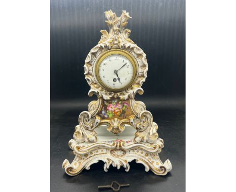 A French porcelain mantel clock rococo scroll moulded case and stand 
