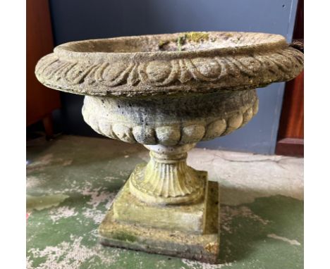 A concrete urn style garden planter