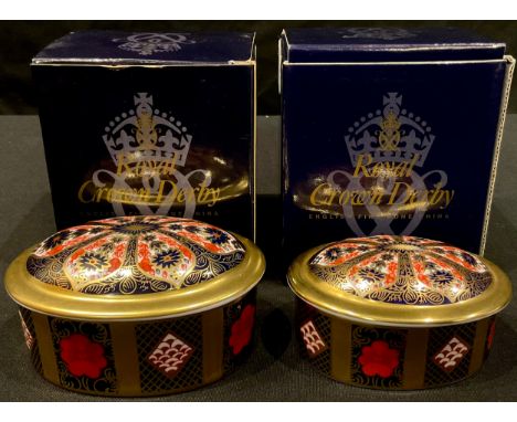 A Royal Crown Derby oval trinket pot and cover, solid gold band, first quality, 10cm wide, boxed; another smaller, solid gold