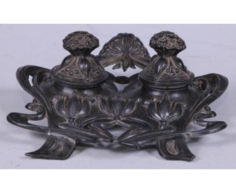 An Art Nouveau pewter inkstand or double inkwell, cast with flower heads and whiplash stems, 16.5cm wide 