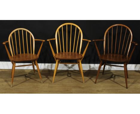 Three Ercol Windsor arm chairs, the largest 88.5cm high, 66.5cm wide, the seat 41cm wide and 35cm deep (3) 