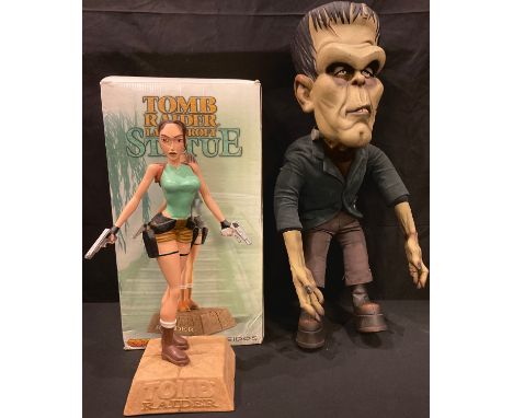 A resin model of Tomb Raider's Lara Croft, 38cm, boxed; a novelty Frankenstein's Monster bendy limbed model (2) 