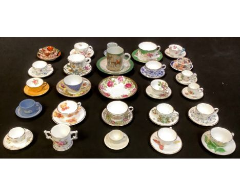 A collection of 19th century and later miniature teacups and saucers, Wedgwood Jasperware, Royal Crown Derby Posie, Davenport