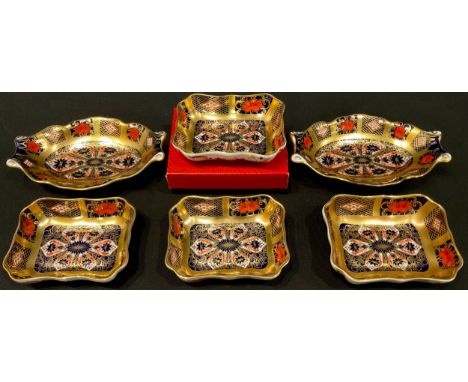 An associated pair of Royal Crown Derby Imari palette 1128 pattern shaped oval pin dishes, one a first quality, the other a s