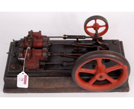 A vintage twin cylinder horizontal engine on wood base 3/4 inch bore x 2 inch stroke, side by side cylinders with end drain c