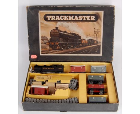 A Pyramid Toys Trackmaster goods train set, containing 0-6-2 clockwork tank engine 5 wagons track oval, together with a Trian