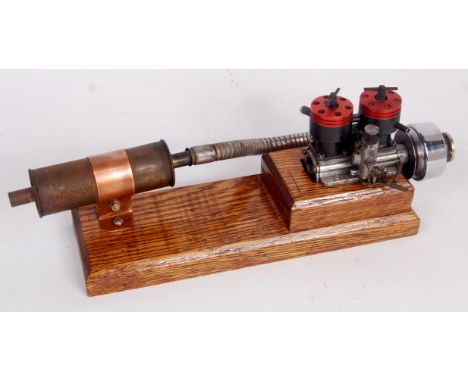 A Taplin twin cylinder diesel engine, unusual, mounted on wooden plinth, vendor states it can be run on D1000 diesel, engine 