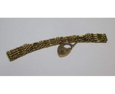 A four bar gate bracelet, faintly stamped '9' with padlock clasp, gross weight 20g  