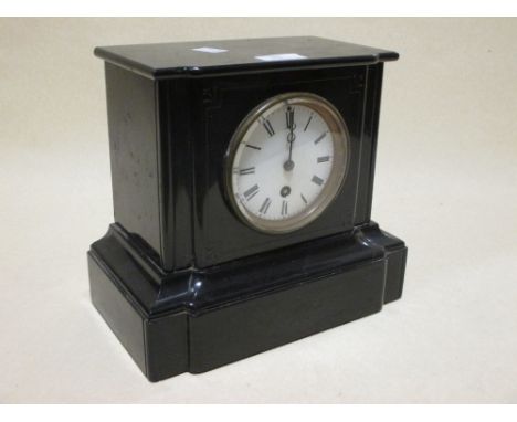 A black marble mantel clock, an oak tantalus, and a suitcase  