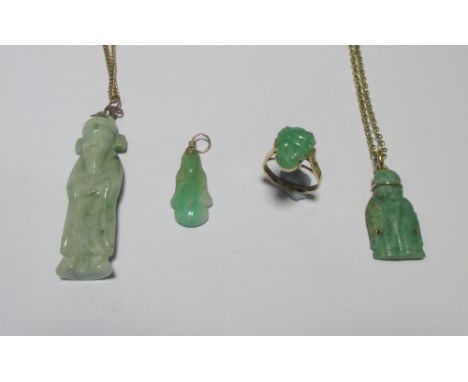 A jade buddha ring set in yellow metal stamped 585, size K, two carved jade pendants on yellow metal chains and a smaller jad