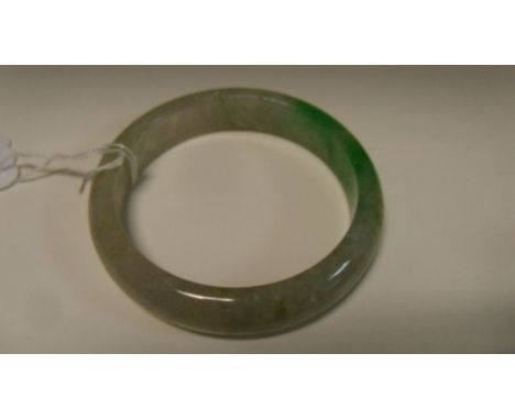 A Chinese green jadeite bangle, the outer diameter 7.5cm (3 in)  Good