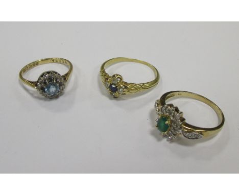 An 18ct aquamarine and diamond ring, London 1990, size M-N, an emerald and diamond cluster ring stamped 375, size N-O and a s