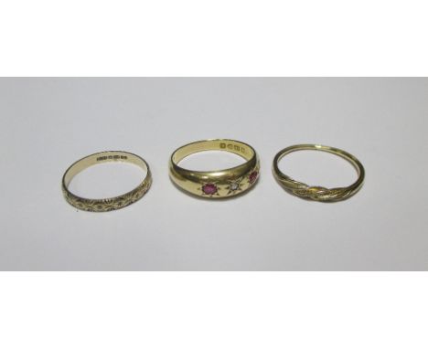 An 18ct three stone ruby and diamond ring, Chester 1907, a 9ct gold ring and another unmarked yellow precious metal ring (3) 