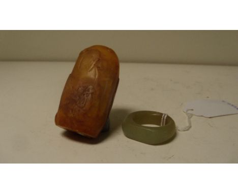 A Chinese nephrite jade archer's ring and a Shoushan stone seal, 5.5cm (2.25 in) high (2)  Good