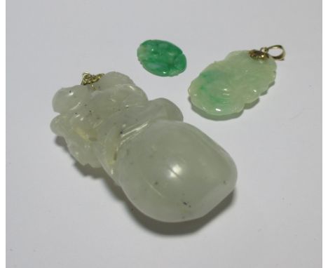 A carved jade pendant of a monkey on a peach, 5.5cm long, together with two other smaller jade pendants (3)  