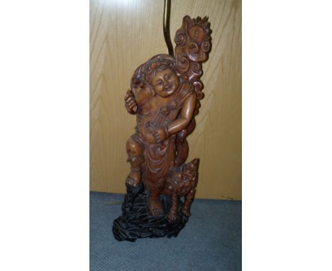 A 20th century hardwood figure of Liu Hai with familiar toad, 61cm (24 in) high  The cash has been broken from the string tha