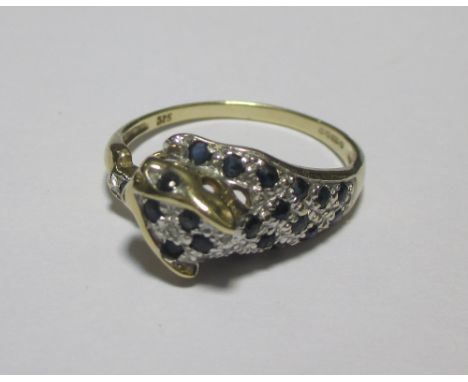 A 9ct panther ring, the head and forelegs pave set with deep blue sapphires and white hardstone, on a tapering band, hallmark