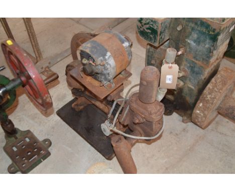 An old stationary engine water pump with an electric motor