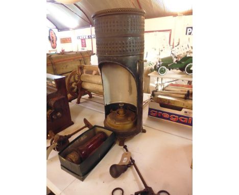 An old oil heater with cranberry glass to centre (R Dent of Belgium)