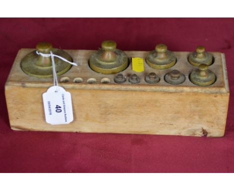 A set of brass scale weights (incomplete)