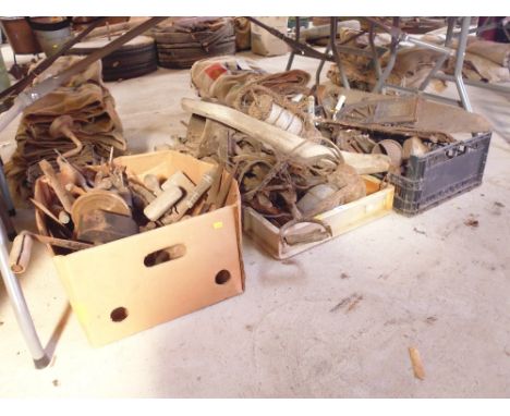 Three boxes containing an old hand grinder; hay knives; tilley lamps; wooden bucket with horse leather etc. 