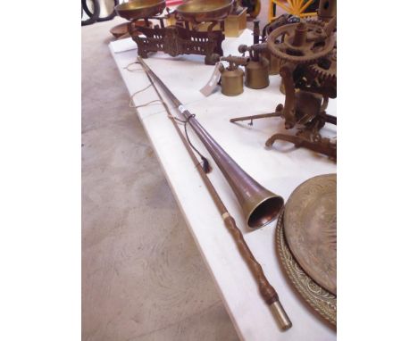A long hunting horn and a horse whip 
